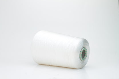 Close-up of brilliant white 100% silk yarn, single-ply strand with a smooth, highly lustrous surface, softly draped. Shimmering.