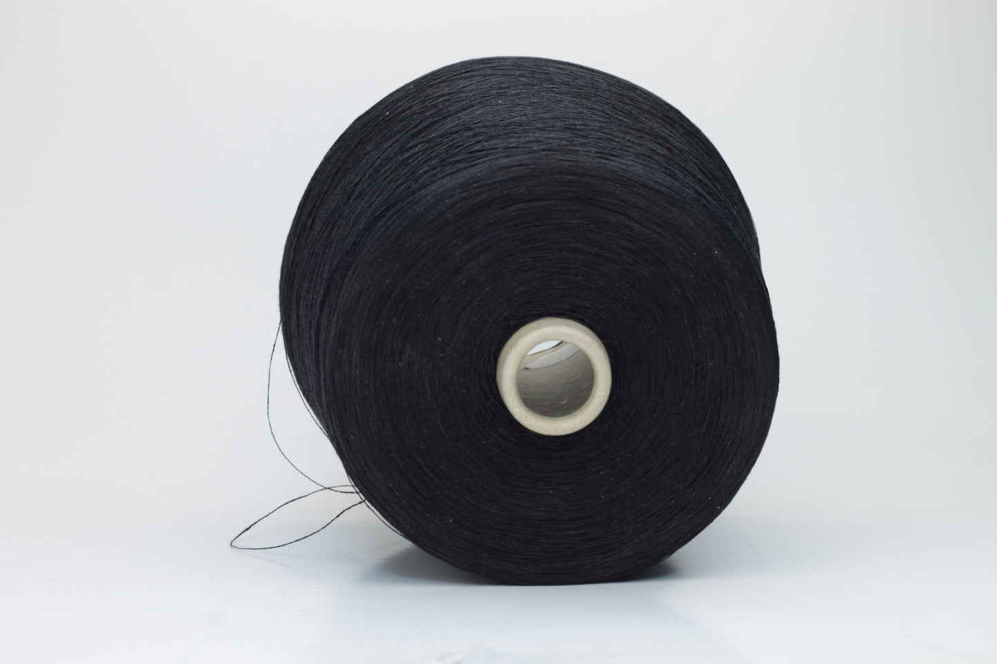 Finely spun Nm 2/26 linen yarn in a rich, deep ardesia slate gray, showcasing a smooth, uniform twist and subtle natural sheen.