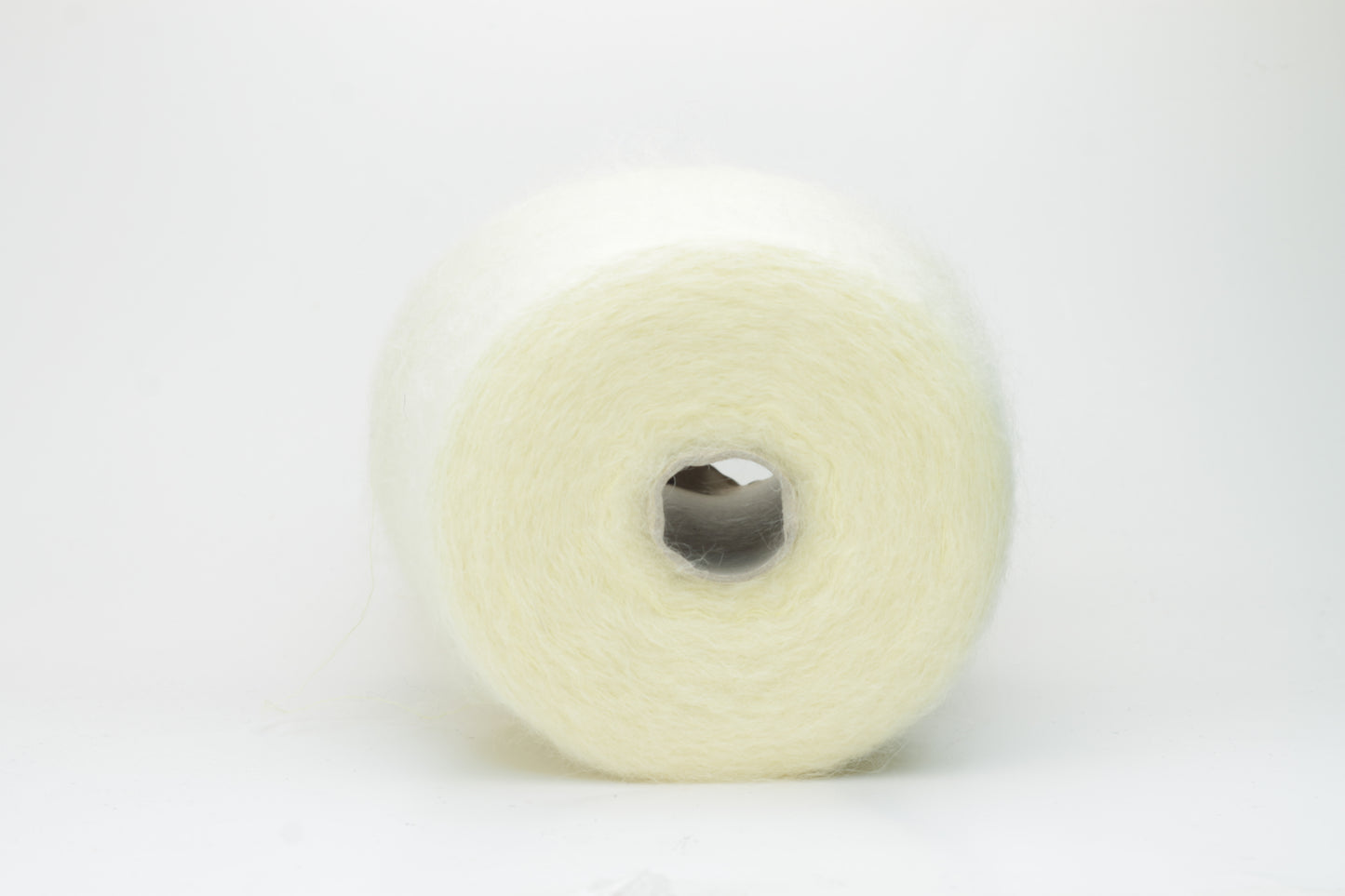 Close-up shot of SuperKidMohair yarn in Light Yellow, revealing a lustrous, fluffy texture with subtle sheen and a tight, well-defined ply twist.