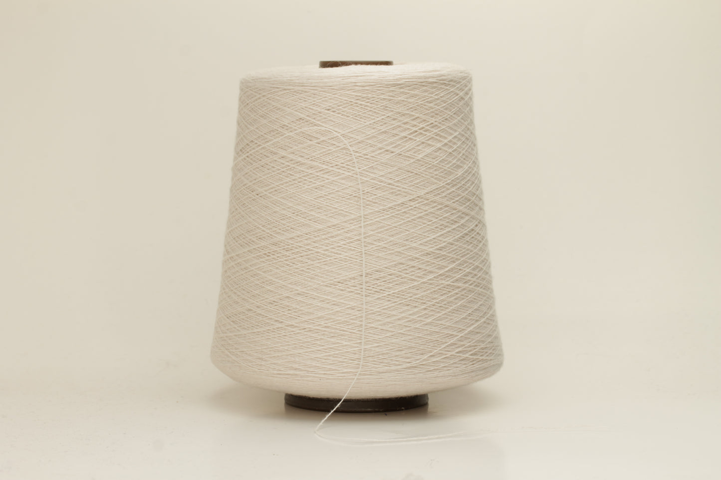 Rich, White 2-ply yarn with a fine, smooth twist; exhibits a subtle sheen and incredibly soft, uniform texture.