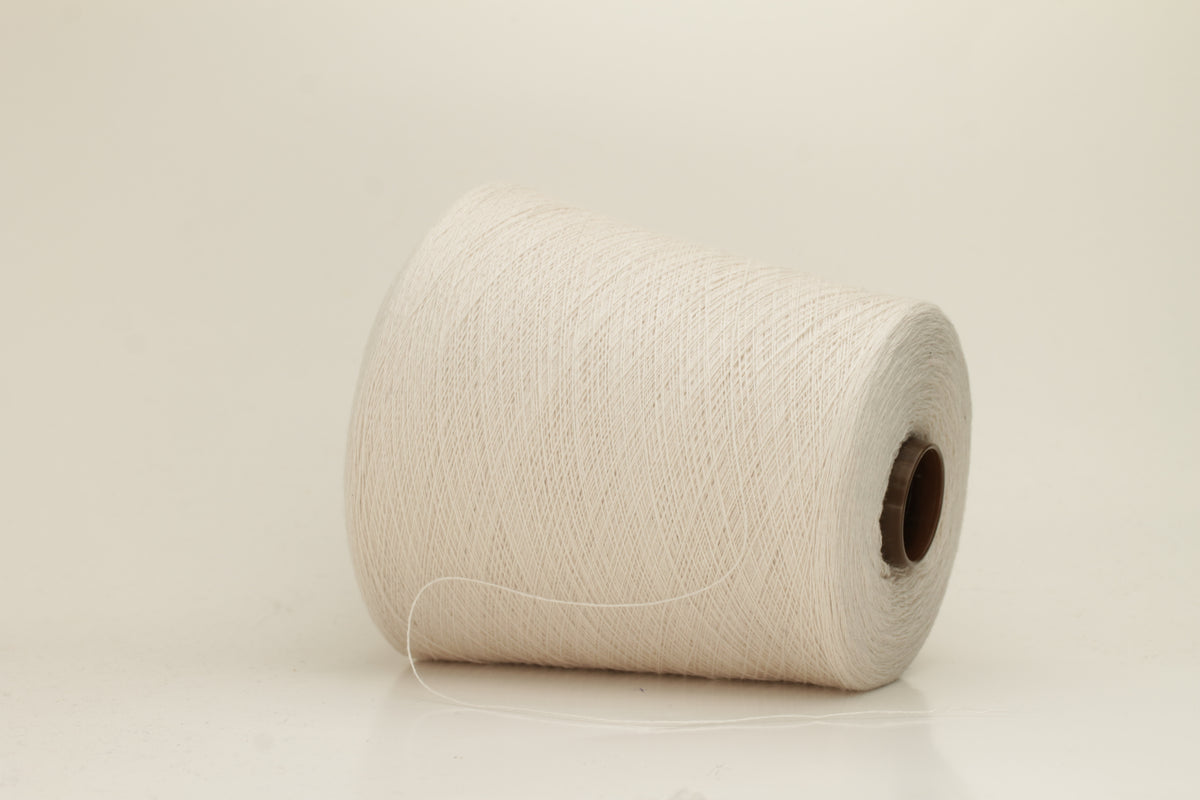 Rich, White 2-ply yarn with a fine, smooth twist; exhibits a subtle sheen and incredibly soft, uniform texture.