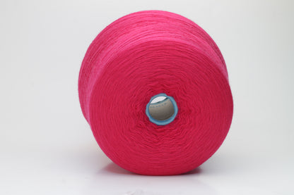 Close-up of vibrant fuchsia 100% merino yarn, showcasing a tight ply twist and a dense, fluffy texture with subtle sheen, perfect for intricate knit designs.