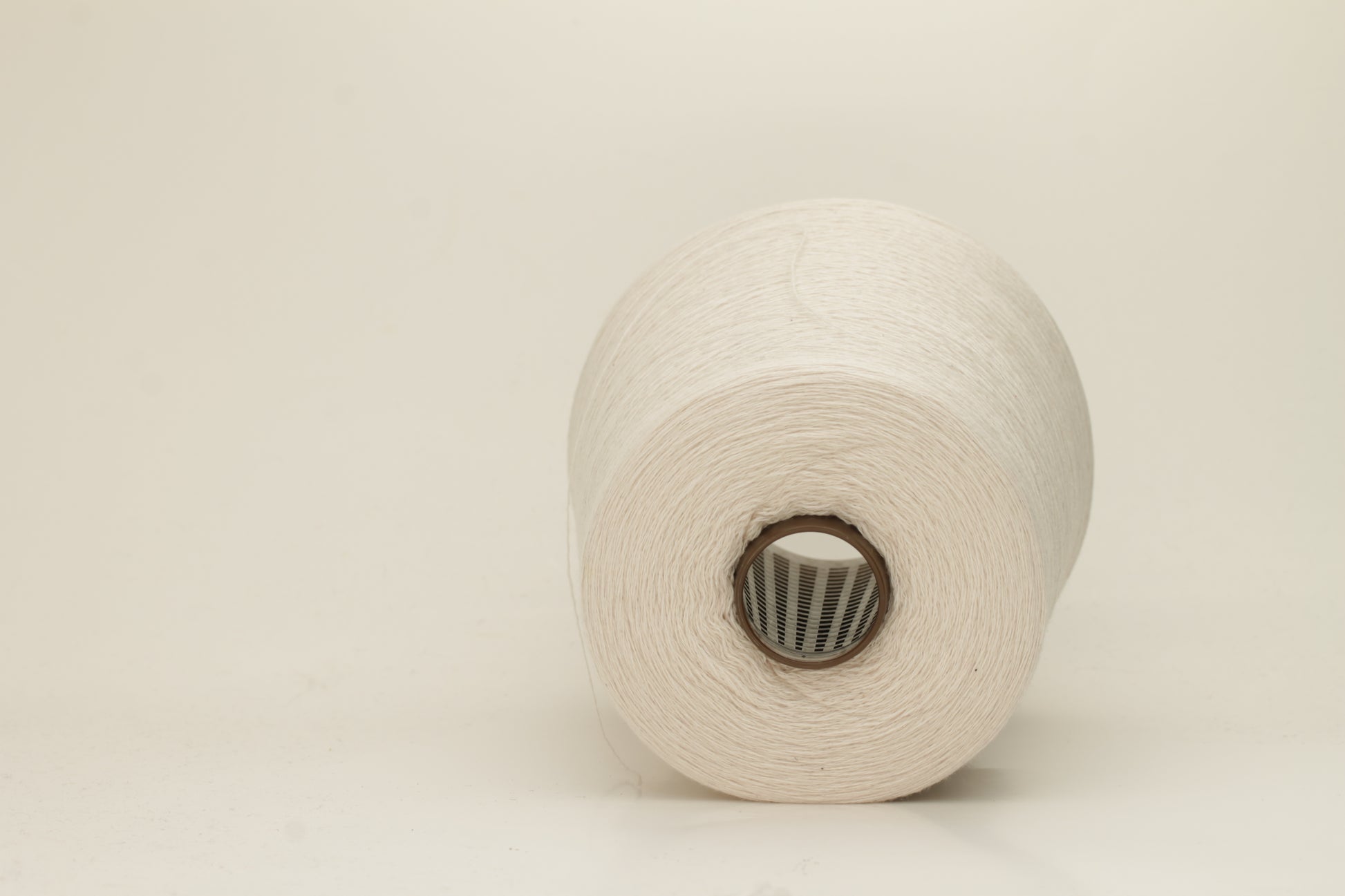 Rich, White 2-ply yarn with a fine, smooth twist; exhibits a subtle sheen and incredibly soft, uniform texture.