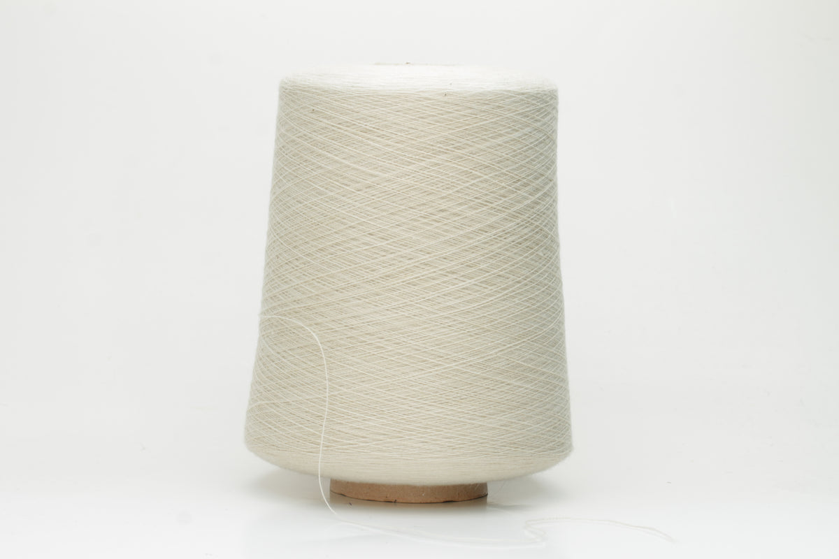 Close-up of a neatly wound cone of fine, smooth 4-ply cotton yarn in a soft off-white hue, showing a subtle matte sheen and even twist.